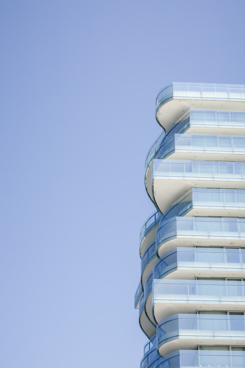 Modern building with curved laminated glass balconies and facade